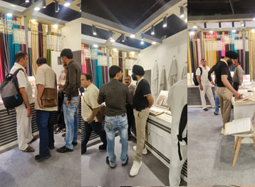 Industry professionals reviewing luxury curtain fabrics and home furnishing collections at Sunny Drape