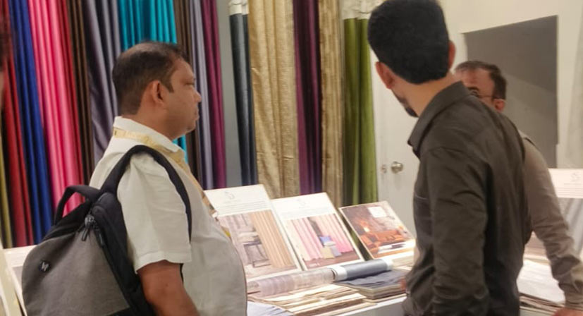 Visitors exploring luxury curtain and upholstery fabric collections at Sunny Drape