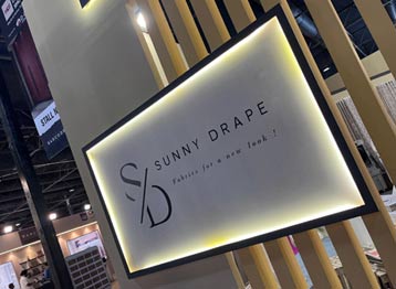 Industry professionals reviewing luxury curtain fabrics and home furnishing collections at Sunny Drape